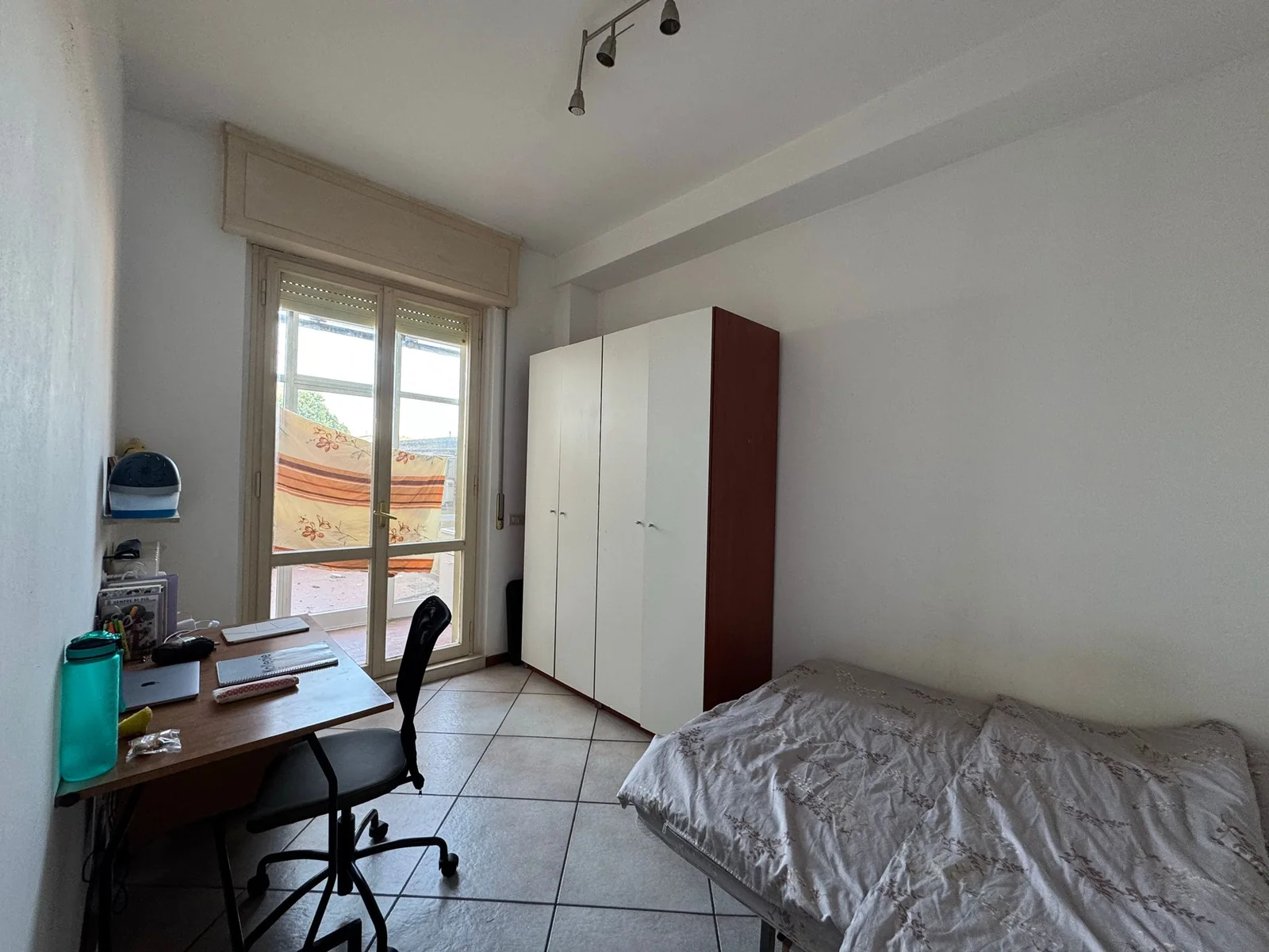 Spacious San Pietro Room 1 with a bed, desk and wardrobe