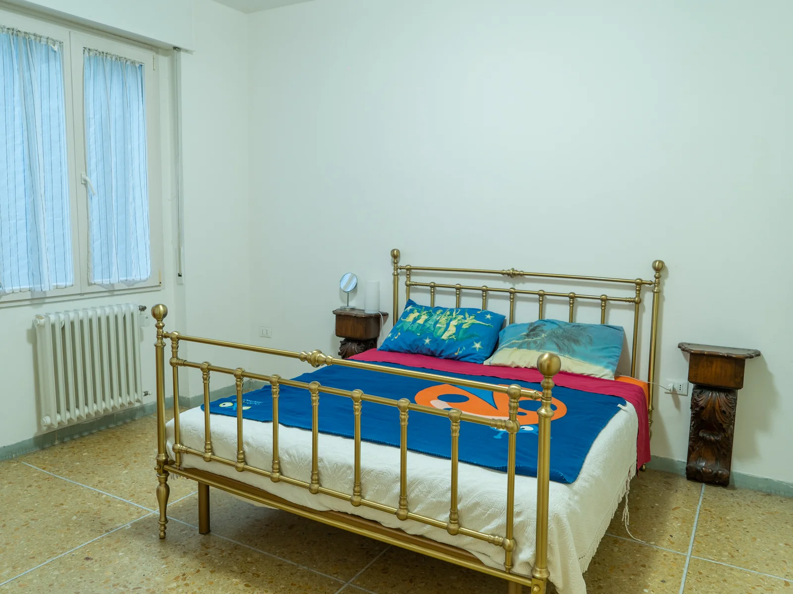Spacious Vittoria Room 3 with a brass bed and bright window